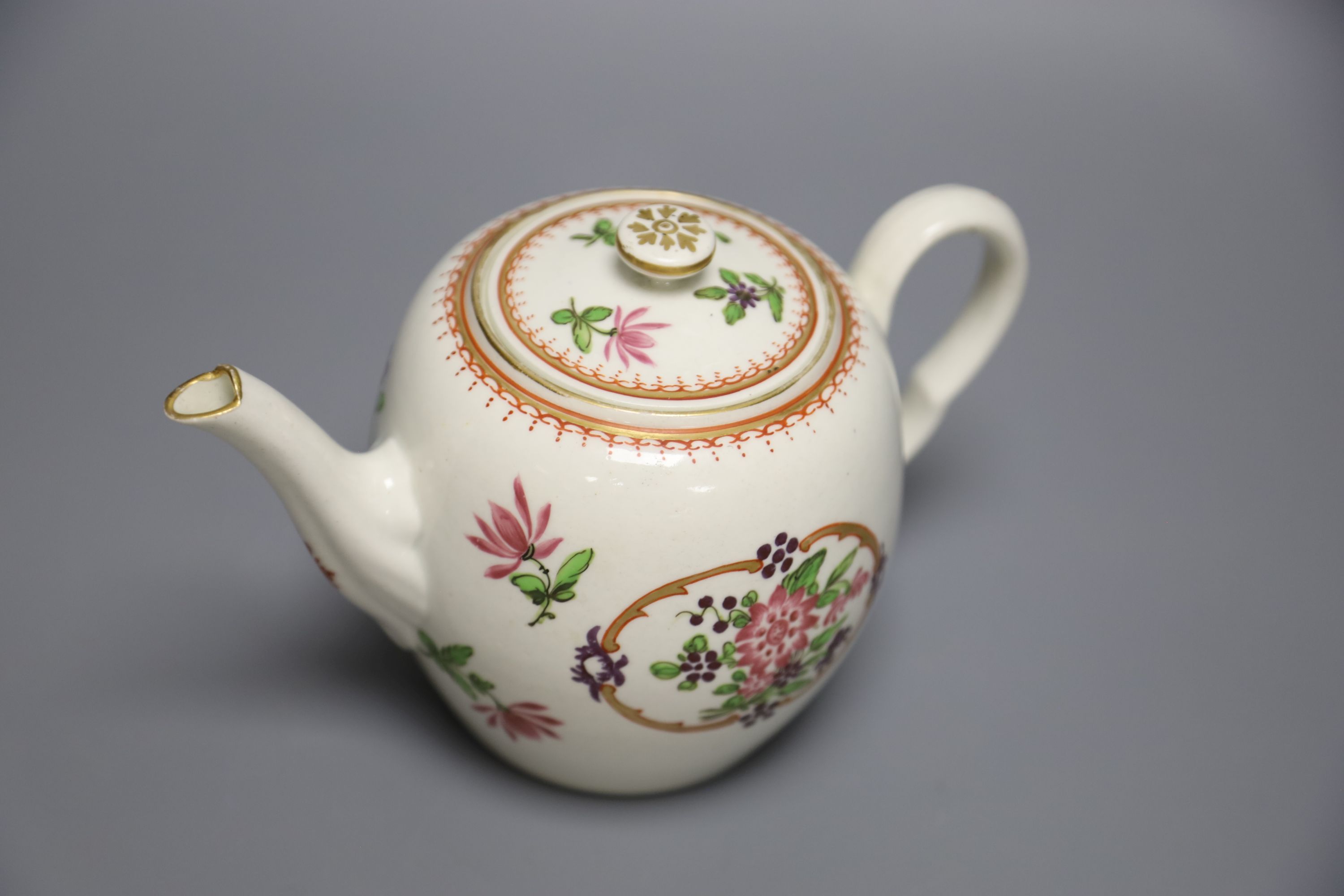 An 18th century Worcester fine teapot and cover of Companie des Indes type painted with Chinese flowers, height 12cm